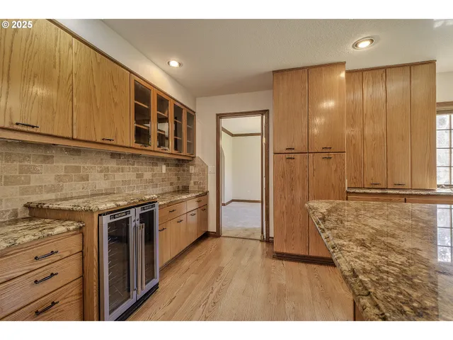 a kitchen with a stove a refrigerator and cabinets
