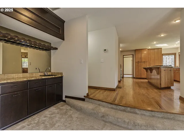a kitchen with a refrigerator and a sink