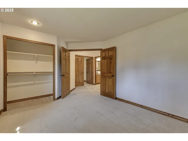 a view of an empty room and closet area