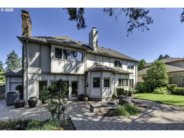 a view of a house with backyard sitting area and garden