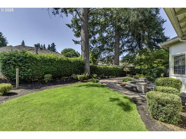 a view of backyard with outdoor seating and green space
