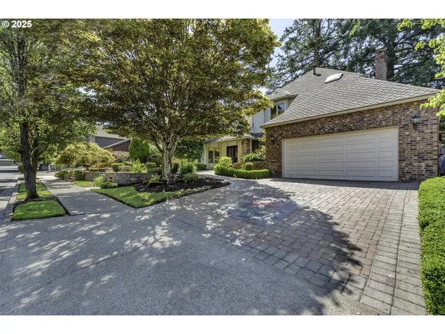 a aerial view of a house with a yard and garage