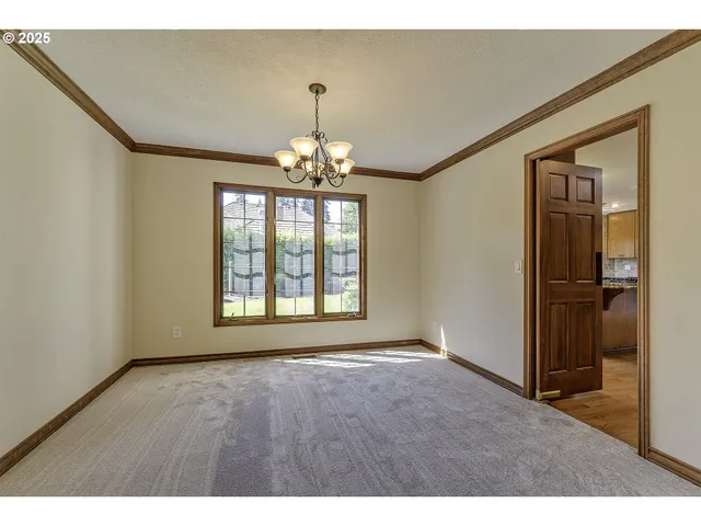 a view of an empty room with glass door