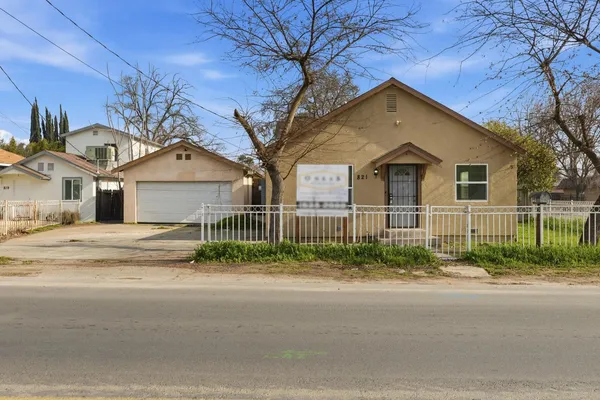 a front view of a house with a garden