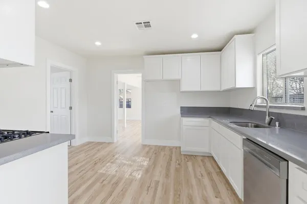 a kitchen with a sink stove and cabinets