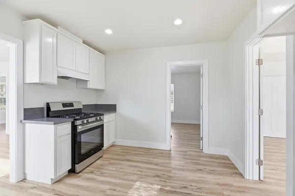 a kitchen with stainless steel appliances granite countertop a stove and a refrigerator