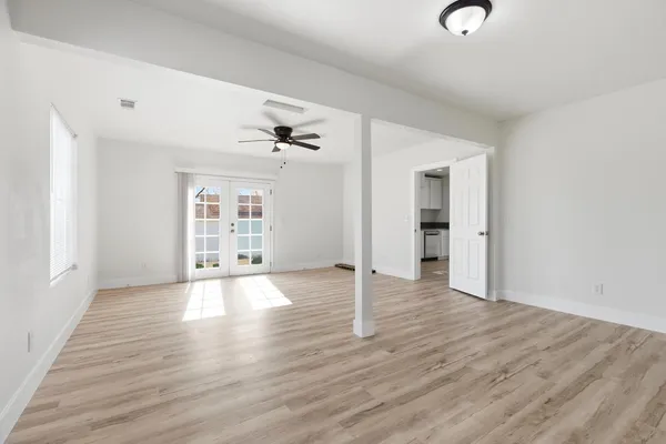wooden floor in an empty room with a window