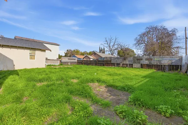 a view of a house with a yard and sitting area