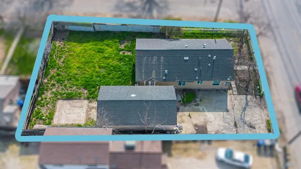 an aerial view of a house with a yard