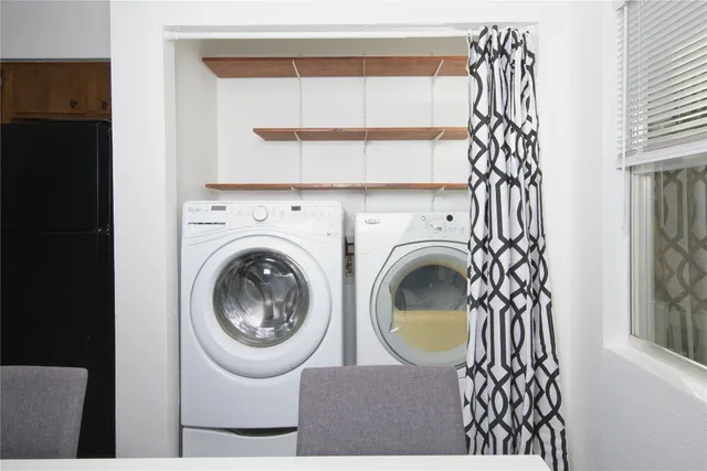 a view of a bedroom with washer and dryer