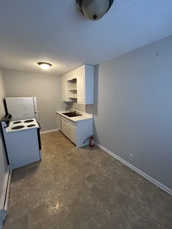 a view of a kitchen with furniture and flat screen tv