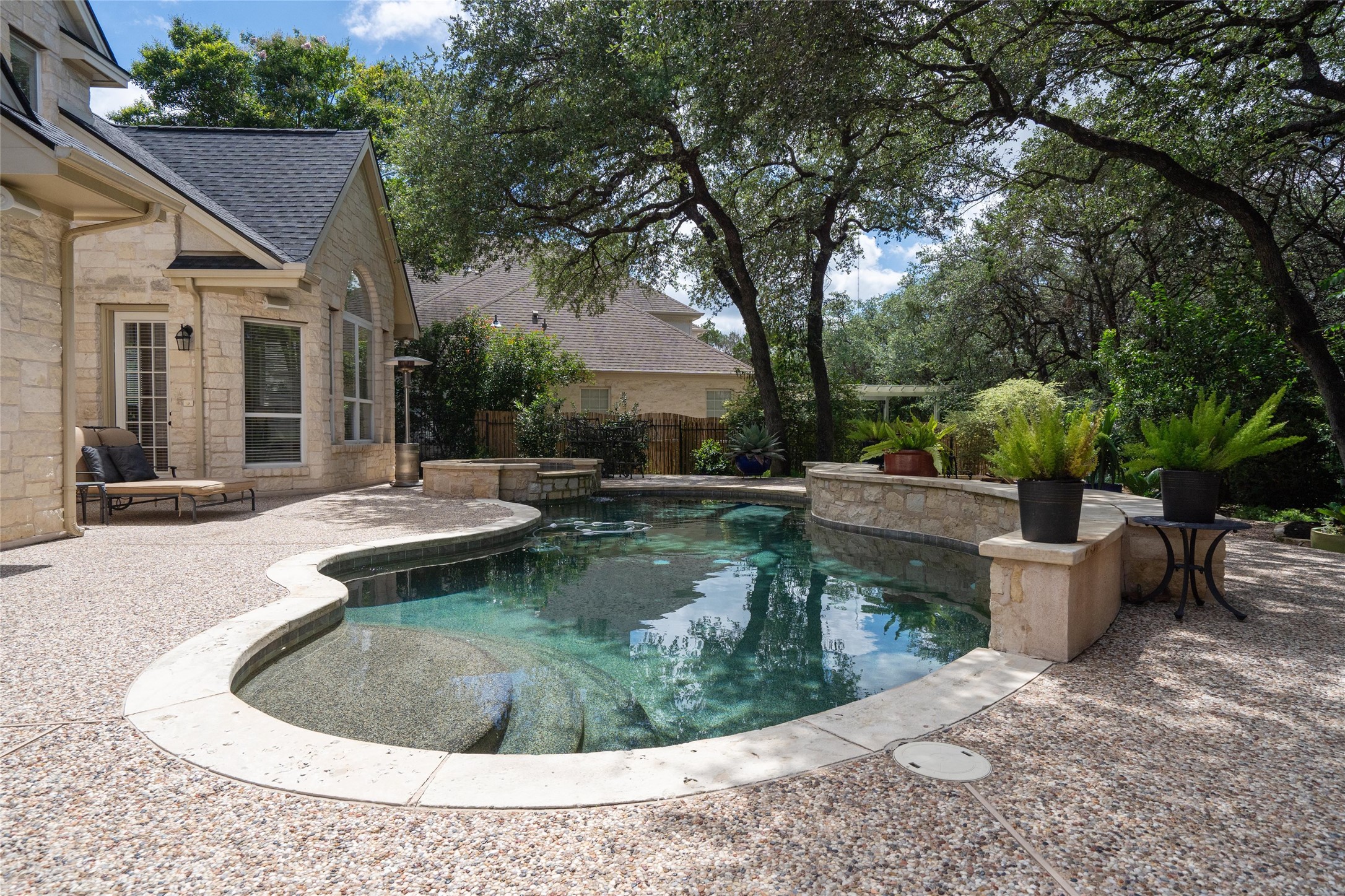 4313 Rio Robles Drive Austin, TX 78746 - Photo 35 of 40 An inviting private pool and patio area await, nestled beneath a canopy of mature trees.