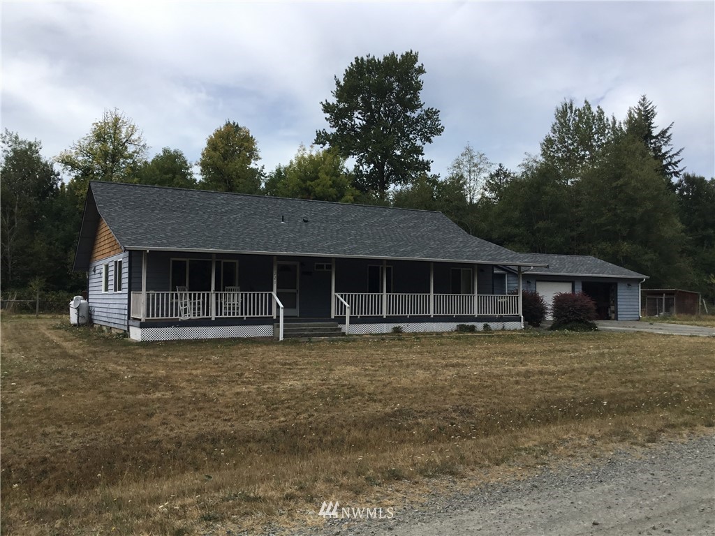 11221 180th Lane Southwest Rochester, WA 98579 - Photo 1 of 24 a front view of a house with a yard