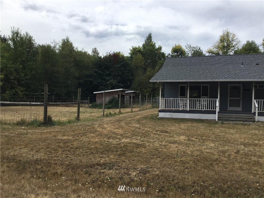 11221 180th Lane Southwest Rochester, WA 98579 - Photo 2 of 24 a front view of a house with a garden