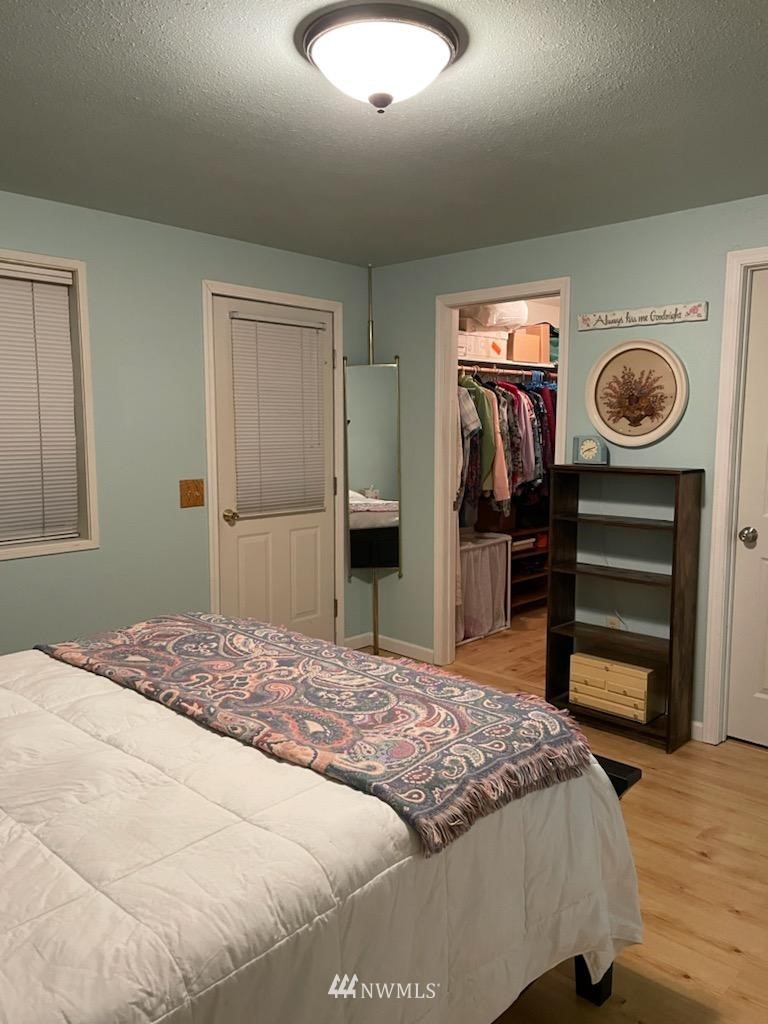 11221 180th Lane Southwest Rochester, WA 98579 - Photo 13 of 24 a bedroom with a bed and a chandelier