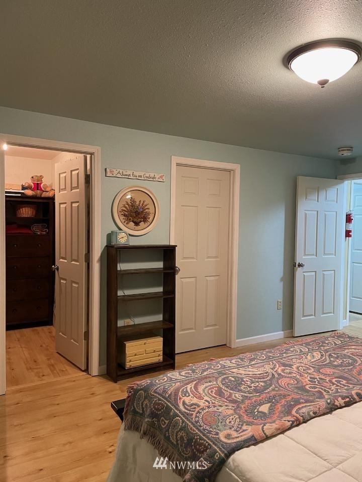 11221 180th Lane Southwest Rochester, WA 98579 - Photo 14 of 24 a bedroom with a bed and a dresser