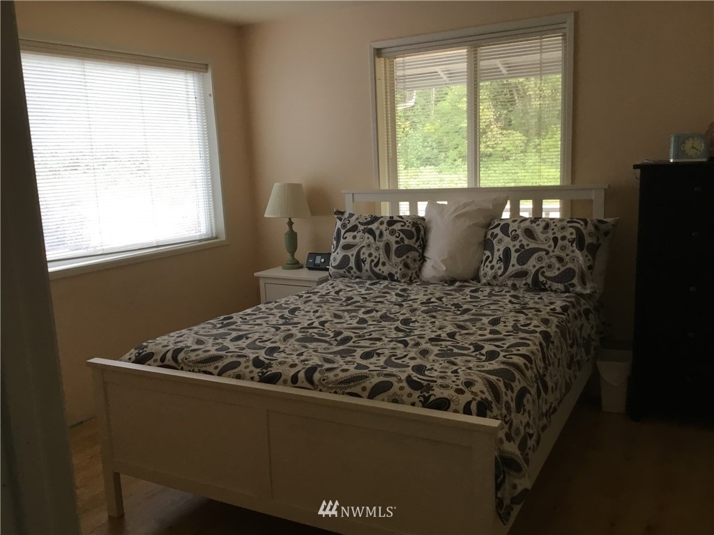 11221 180th Lane Southwest Rochester, WA 98579 - Photo 17 of 24 a bed sitting in a bedroom next to a window