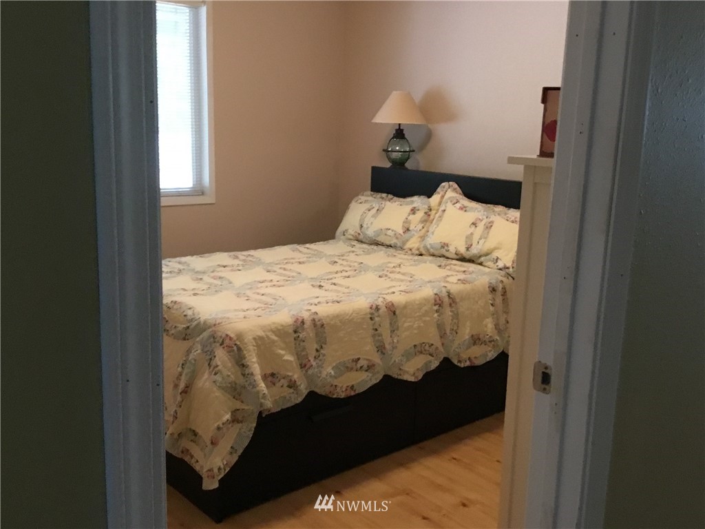11221 180th Lane Southwest Rochester, WA 98579 - Photo 18 of 24 a bed sitting in a bedroom next to a window