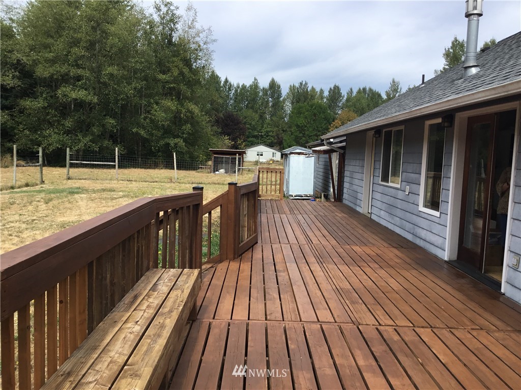 11221 180th Lane Southwest Rochester, WA 98579 - Photo 20 of 24 a balcony with wooden floor and yard in the back
