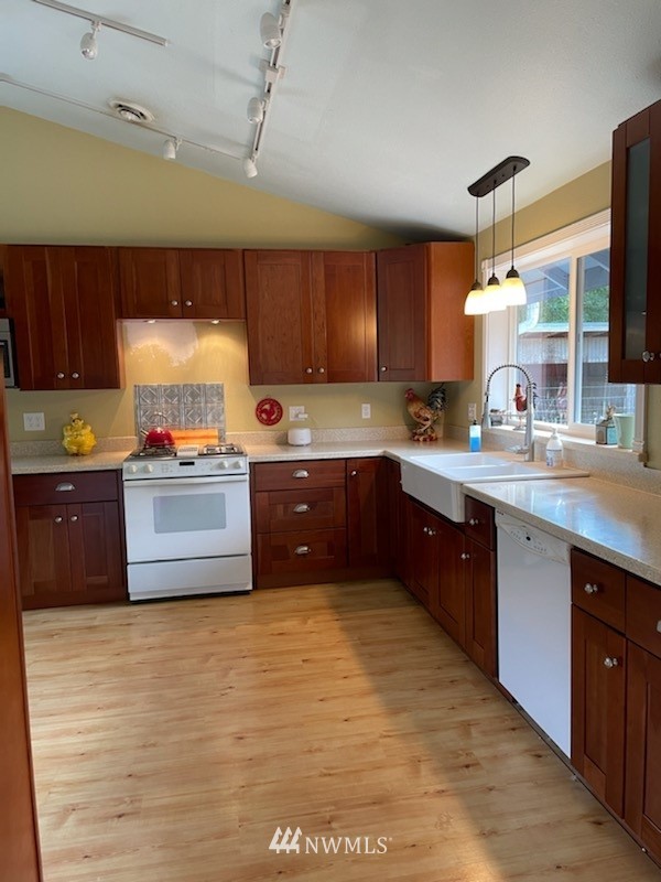 11221 180th Lane Southwest Rochester, WA 98579 - Photo 4 of 24 a kitchen with granite countertop a sink cabinets and window