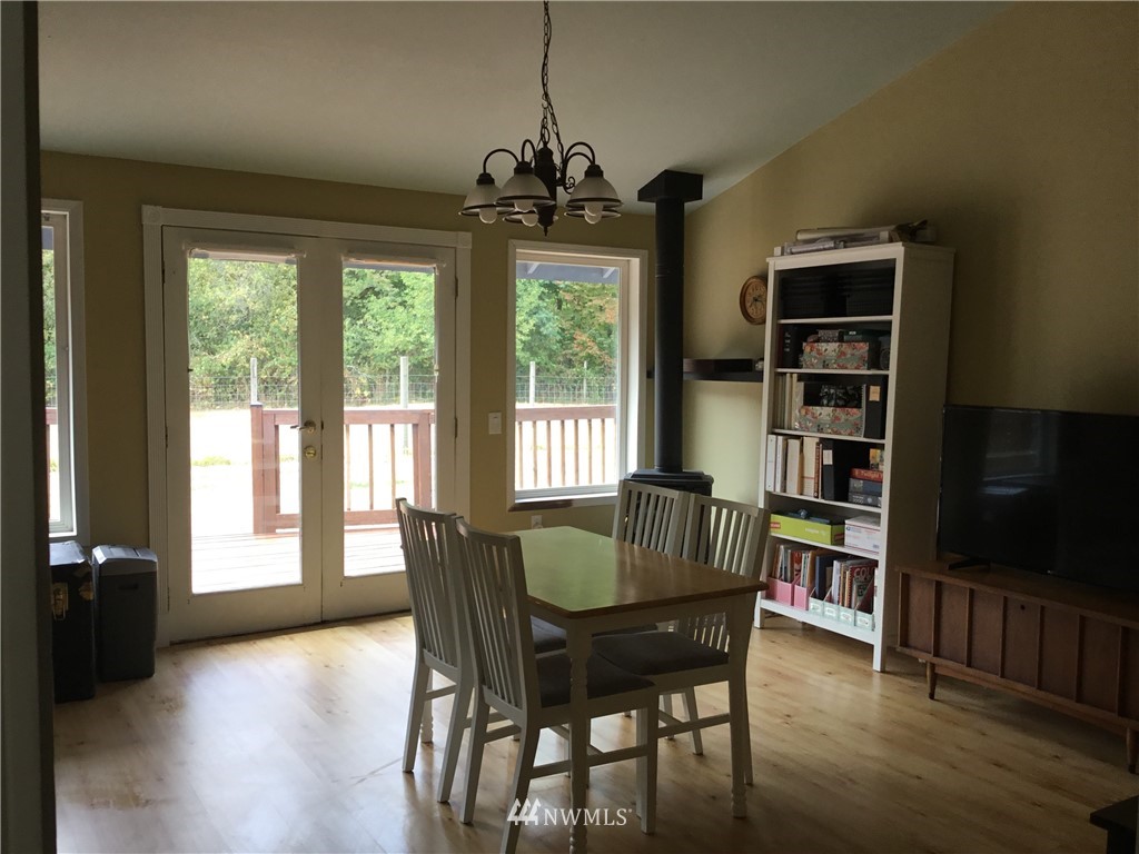 11221 180th Lane Southwest Rochester, WA 98579 - Photo 10 of 24 a dining room with furniture window and wooden floor