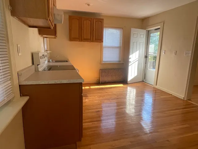 a kitchen with wooden floor and a sink