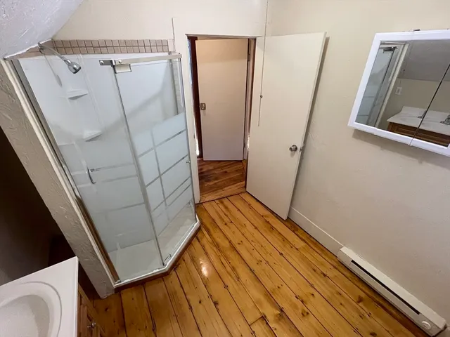 a view of front door and wooden floor