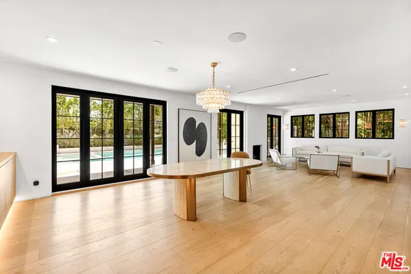 a view of a living room and a floor to ceiling window and wooden floor