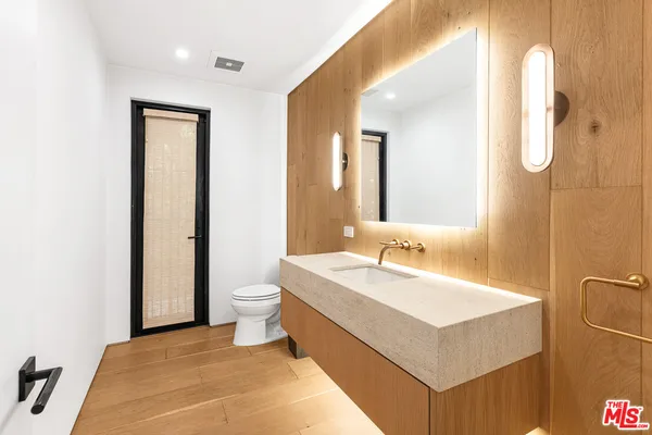 a bathroom with a double vanity sink mirror and toilet