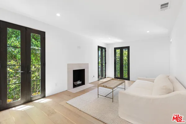 a living room with furniture a window and a fireplace