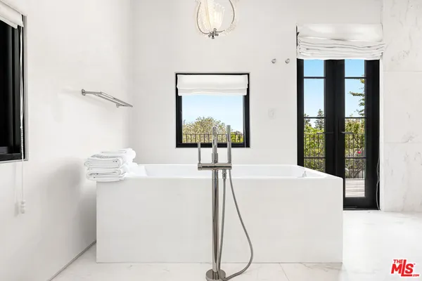 a view of a white house with a yard