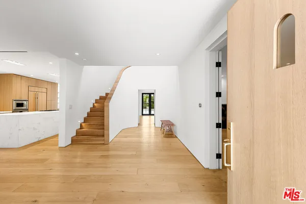 a view of an entryway with wooden floor