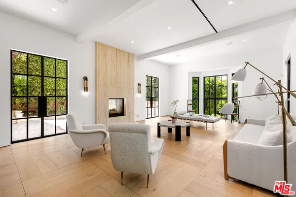 a living room with furniture and a large window with outer view