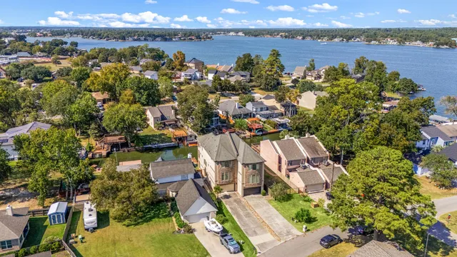 an aerial view of residential building with outdoor space and lake view
