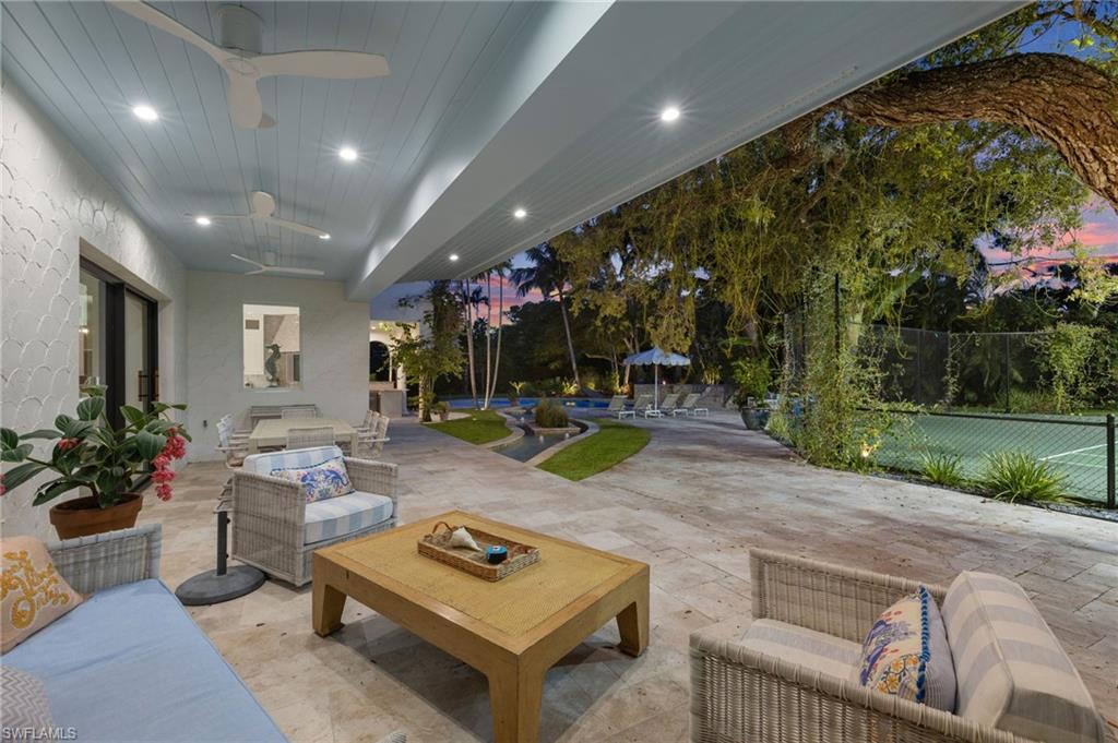 111 Caribbean Road Naples, FL 34108 - Photo 46 of 50 a room with lots of potted plants and a projector
