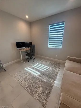 a living room with a couch and a dresser