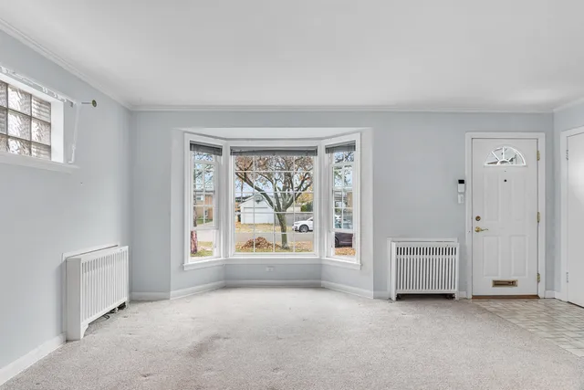an empty room with windows and closet