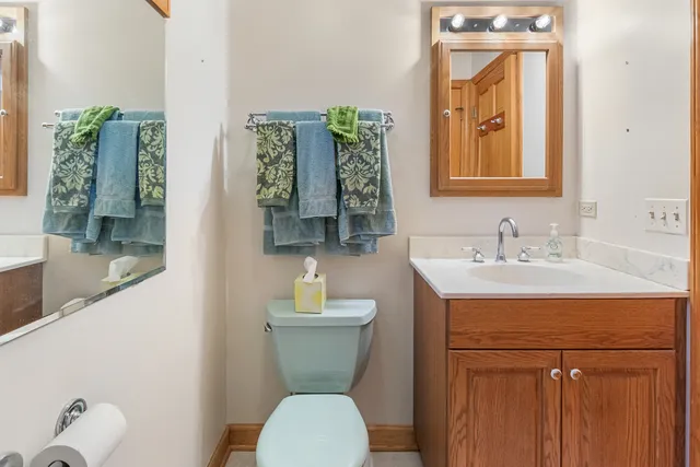 a bathroom with a toilet sink and mirror