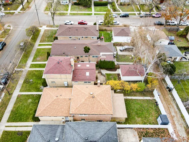 an aerial view of a house with a garden and trees