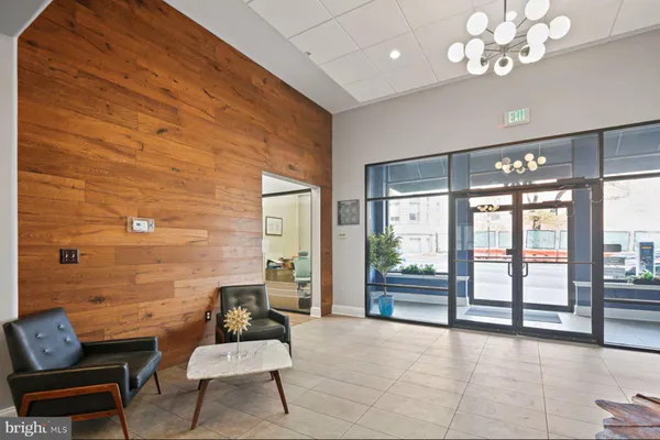 a living room with furniture and floor to ceiling window