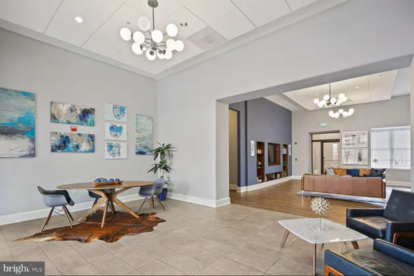 a living room with furniture and a chandelier