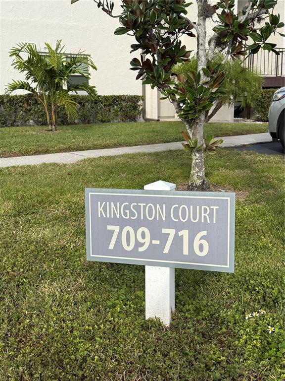 7701 Starkey Road, Unit 711 Seminole, FL 33777 - Photo 19 of 21 a sign broad in front of the red white house