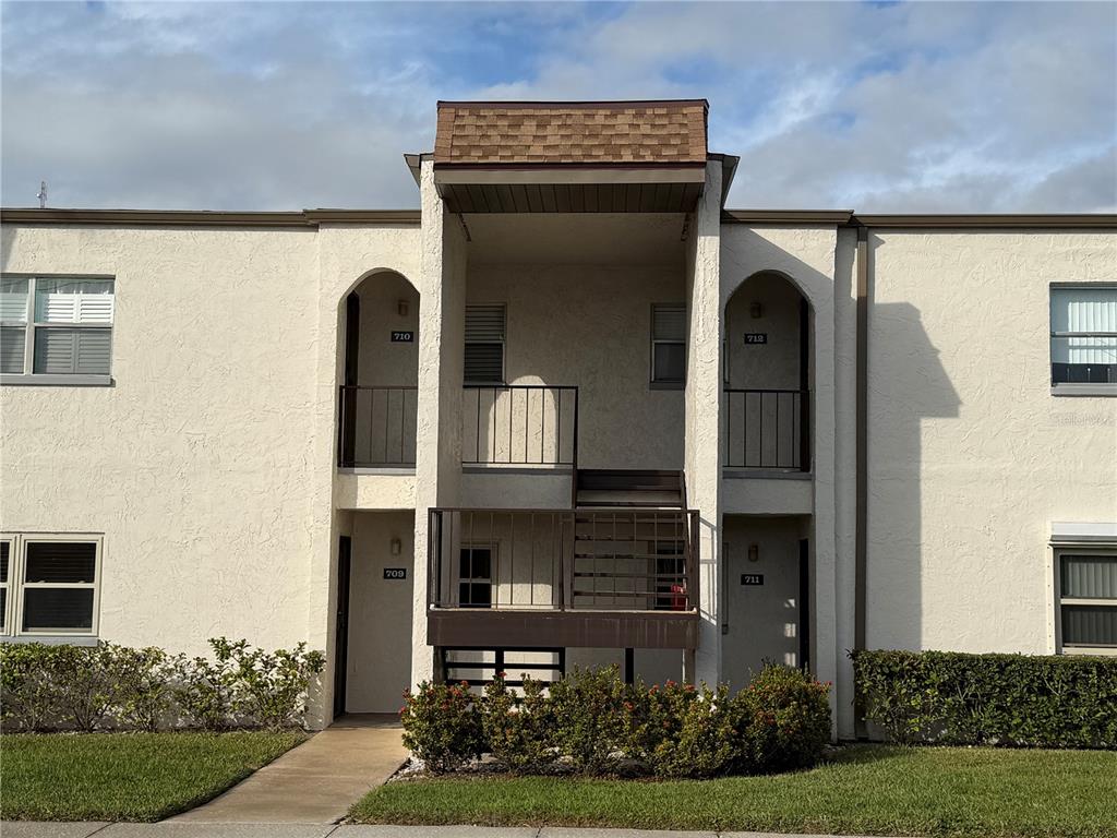 7701 Starkey Road, Unit 711 Seminole, FL 33777 - Photo 21 of 21 a front view of a house with garden