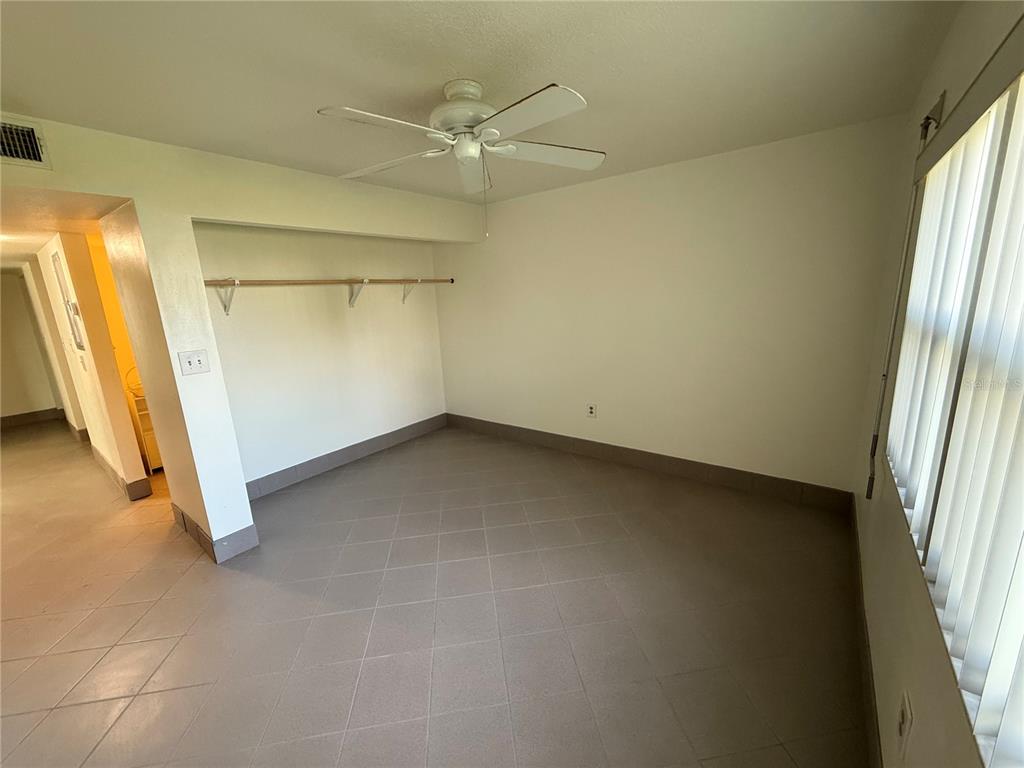 7701 Starkey Road, Unit 711 Seminole, FL 33777 - Photo 6 of 21 an empty room with a fireplace and a window