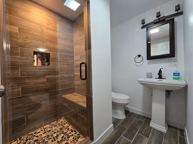 a bathroom with a sink toilet and shower