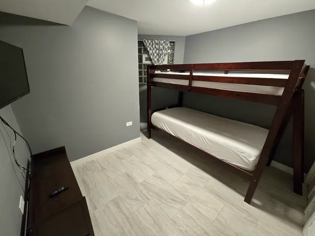 a bedroom with a bed and lamp
