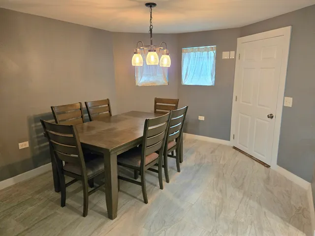 a view of a dining room with furniture and window