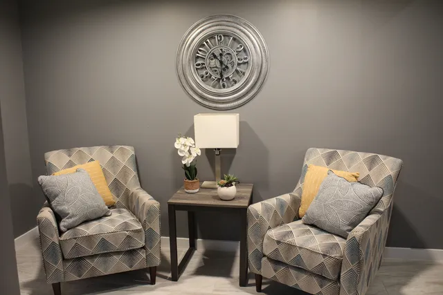 a view of a livingroom with furniture and a window