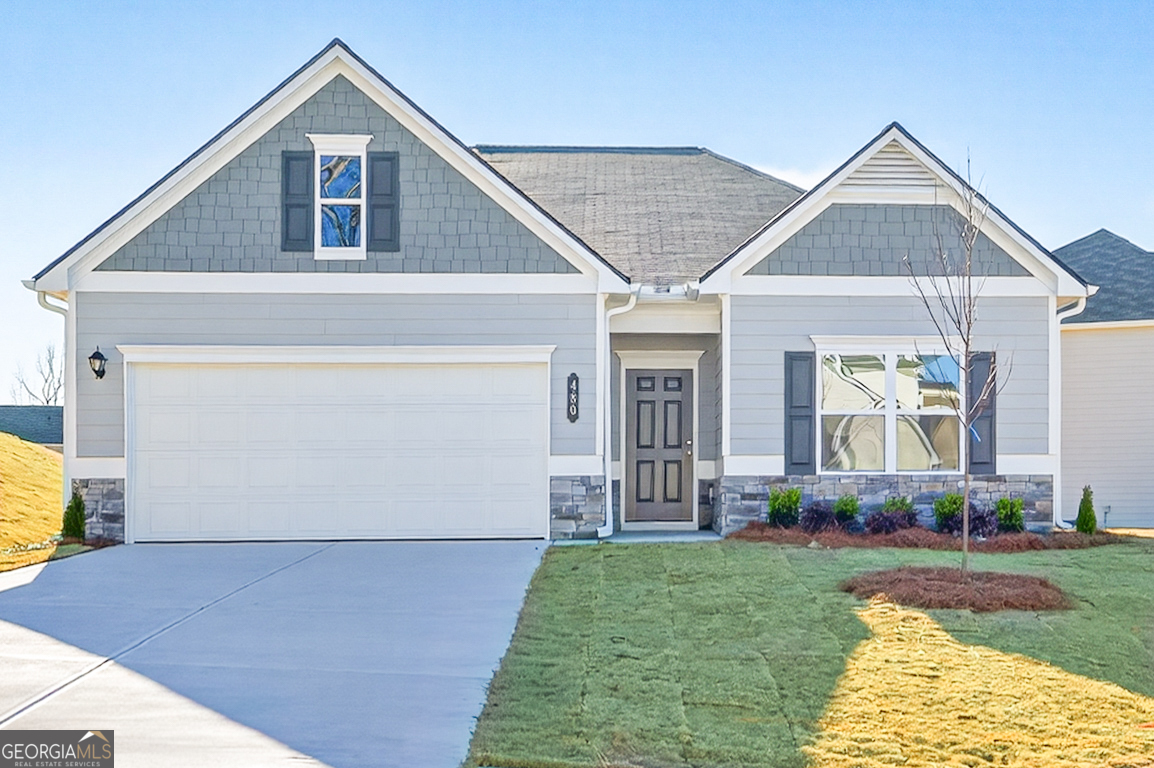 a front view of a house with garden