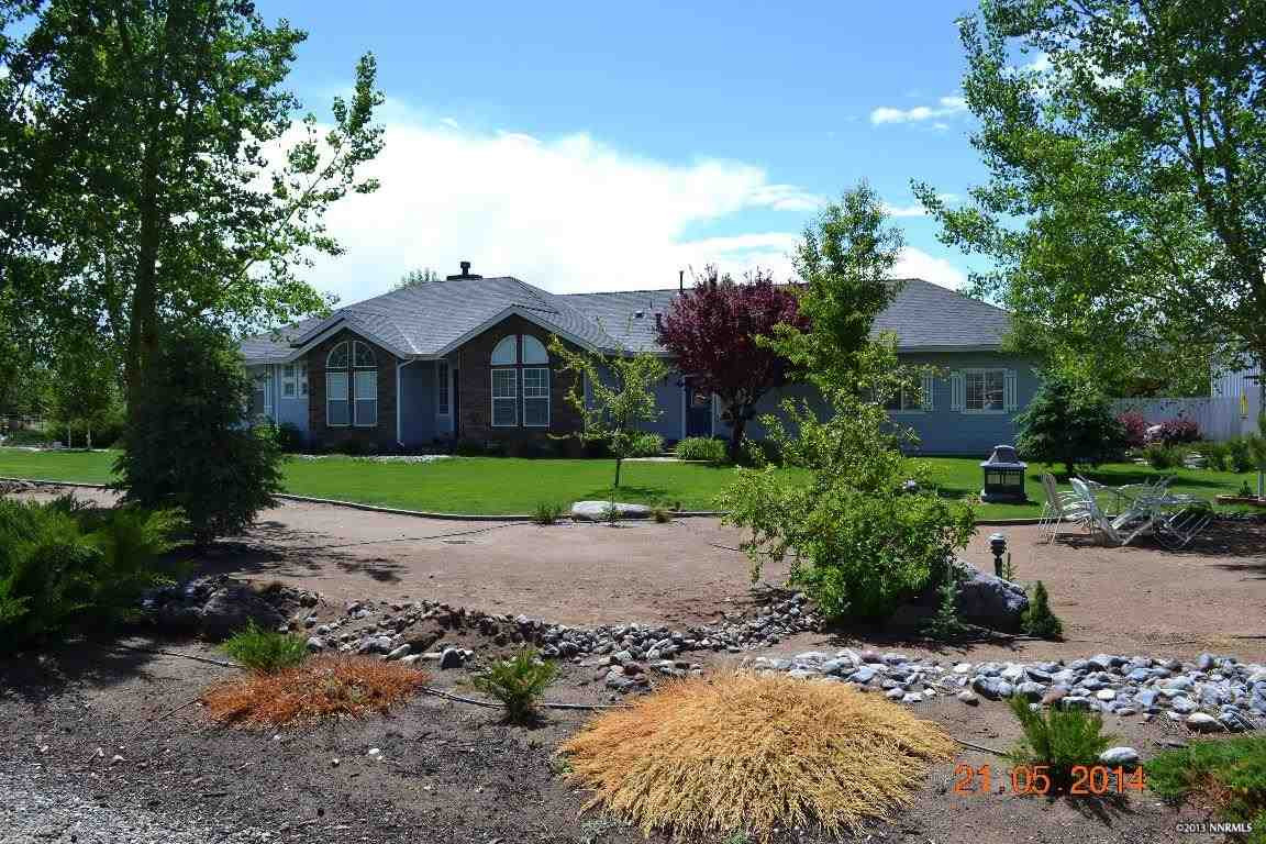 a house with green field in front of it
